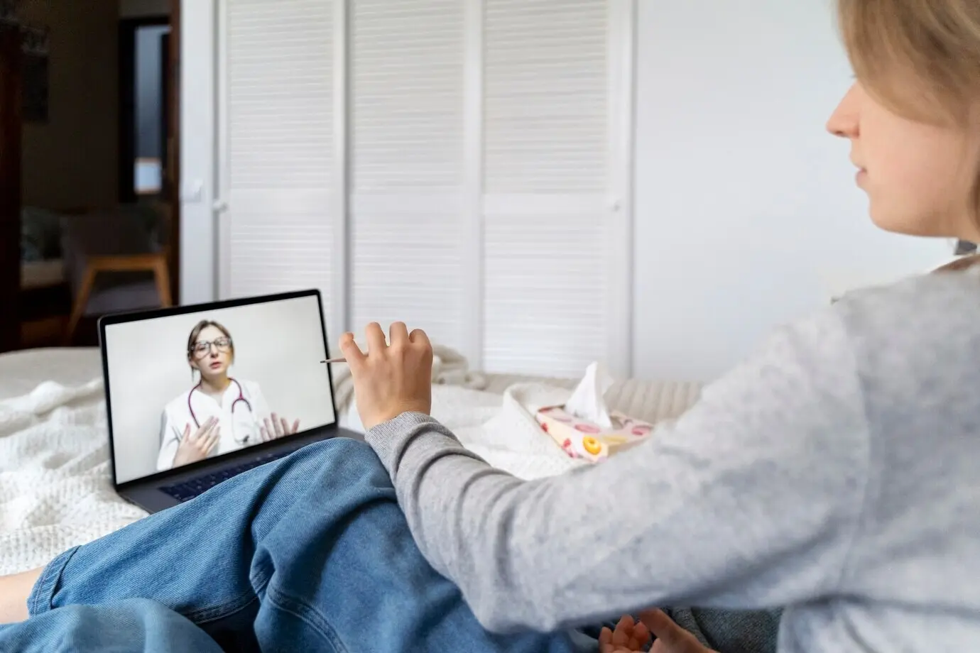 A patient engaged in a teleconsultation with a doctor.