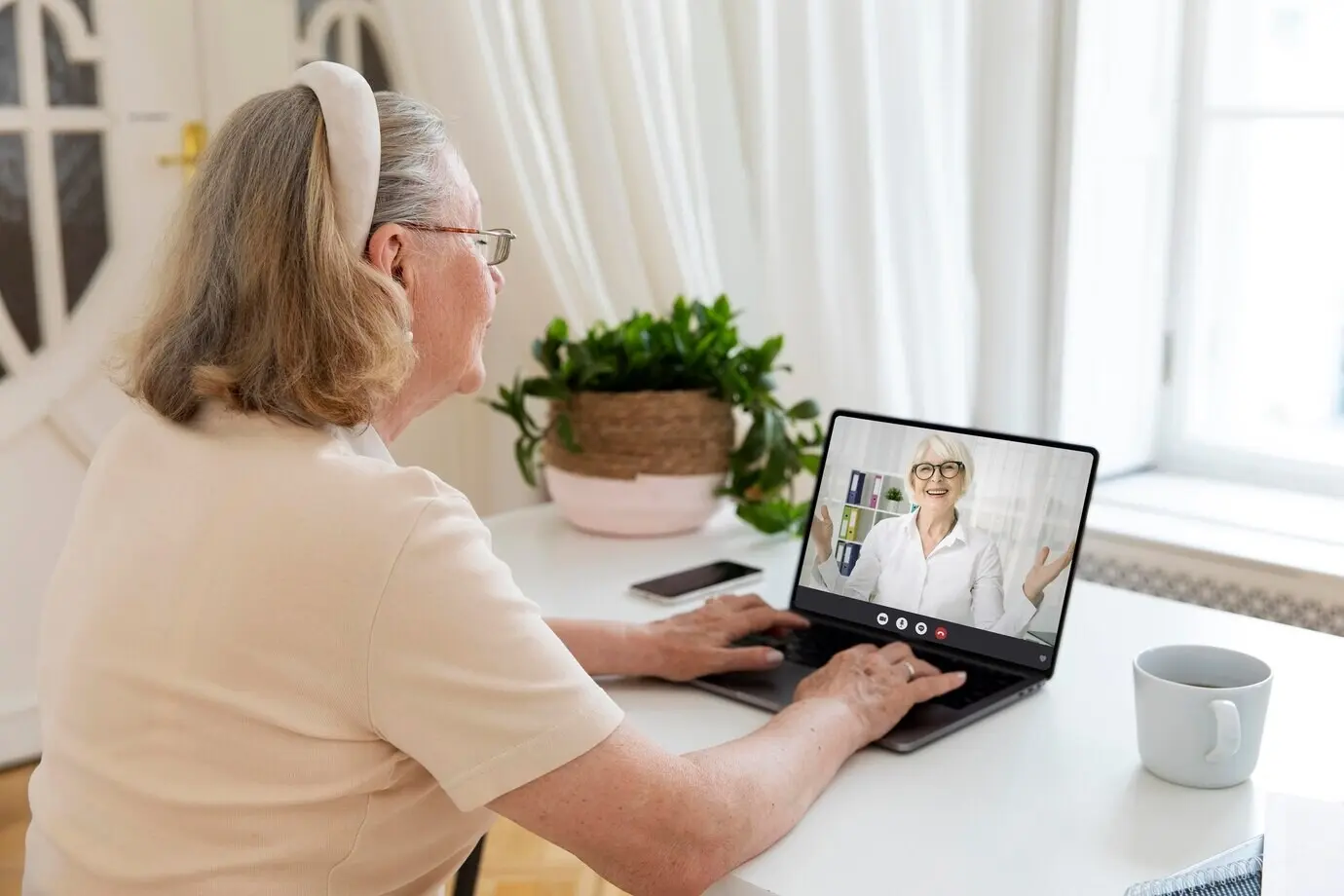 A woman conducting a video call indoors.